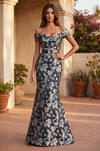 Model wearing the floor-length navy floral off-the-shoulder dress, front view