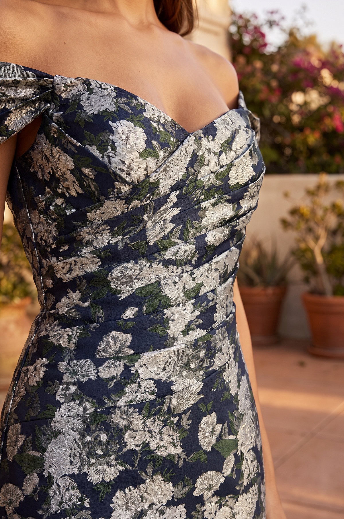Close-up of the ruched bodice and off-the-shoulder neckline on the navy floral dress